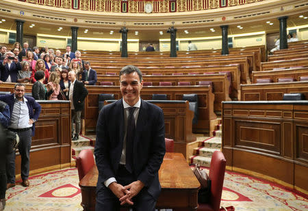 Spain's new Prime Minister and Socialist party (PSOE) leader Pedro Sanchez poses for photographers in the chamber after a motion of no confidence vote at parliament in Madrid, Spain, June 1, 2018. REUTERS/Sergio Perez