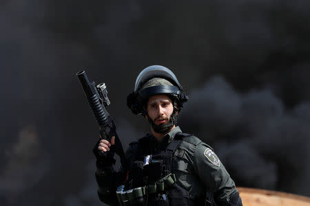An Israeli border police gestures during clashes with Palestinian protesters near the Jewish settlement of Beit El, in the Israeli-occupied West Bank March 20, 2019. REUTERS/Mohamad Torokman