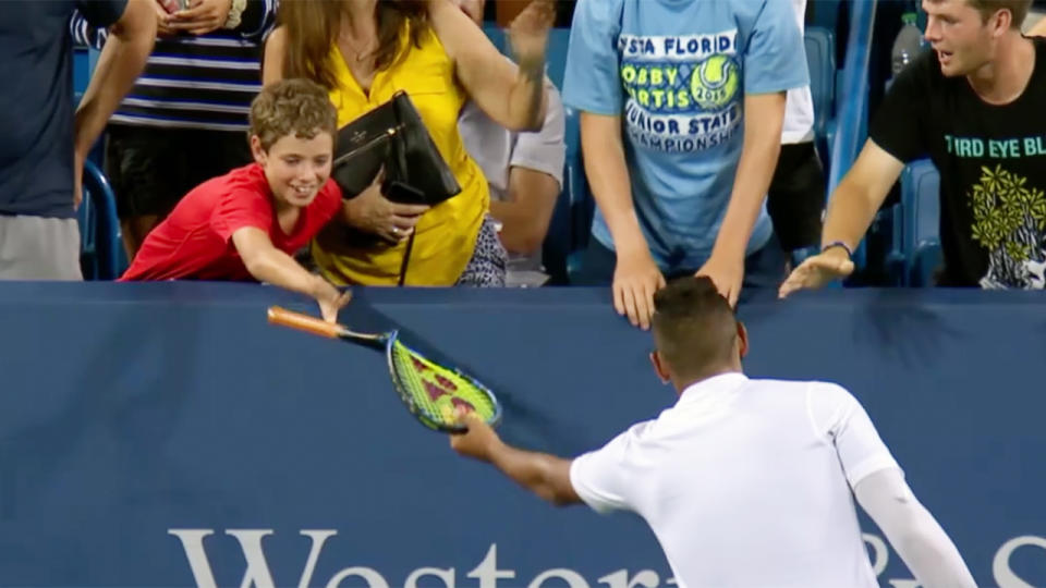 Nick Kyrgios handed his racquet to a young fan in the front row. (Image: ESPN)