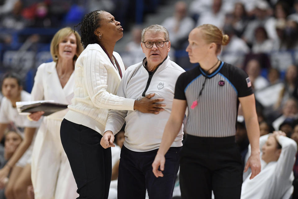 UConn head coach Geno Auriemma is held back by assistant coach Jamelle Elliott in the second half of an NCAA college basketball game against South Carolina, Sunday, Feb. 5, 2023, in Hartford, Conn. (AP Photo/Jessica Hill)