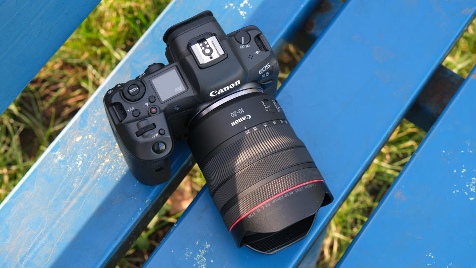 Canon RF 10-20mm F4L IS STM lens mounted on a Canon EOS R5 camera on a blue bench