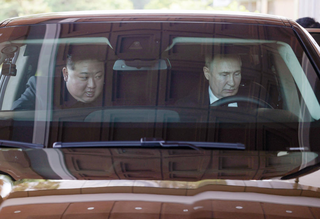 In this pool photograph distributed by the Russian state agency Sputnik, Russian President Vladimir Putin (R) and North Korea's leader Kim Jong Un (L) drive an Aurus car in Pyongyang, on June 19, 2024.  (Photo by Gavriil GRIGOROV / POOL / AFP) / -- Editor's note : this image is distributed by the Russian state owned agency Sputnik - (Photo by GAVRIIL GRIGOROV/POOL/AFP via Getty Images)