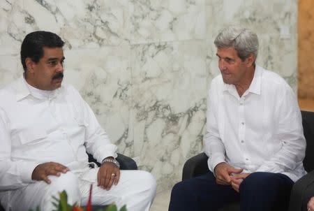 Venezuela's President Nicolas Maduro (L) and U.S. Secretary of State John Kerry talk during their meeting in Cartagena, Colombia September 26, 2016. Miraflores Palace/Handout via REUTERS