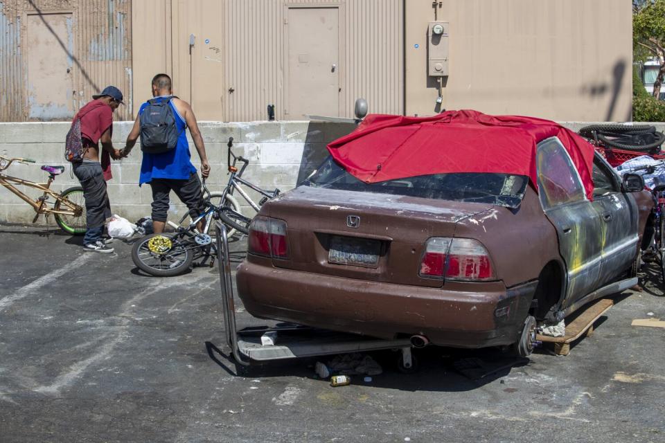 Homeless men in an alley near Moran Street in the Little Saigon community.