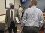 FILE - In this Wednesday, June 24, 2020, file photo, Nevada Gov. Steve Sisolak exits a news conference at the Nevada State Legislature in Carson City, Nev. Sisolak announced Nevada would join California, Washington and North Carolina in requiring individuals wear masks in public places to contain the spread of the coronavirus. (AP Photo/Samuel Metz, File)