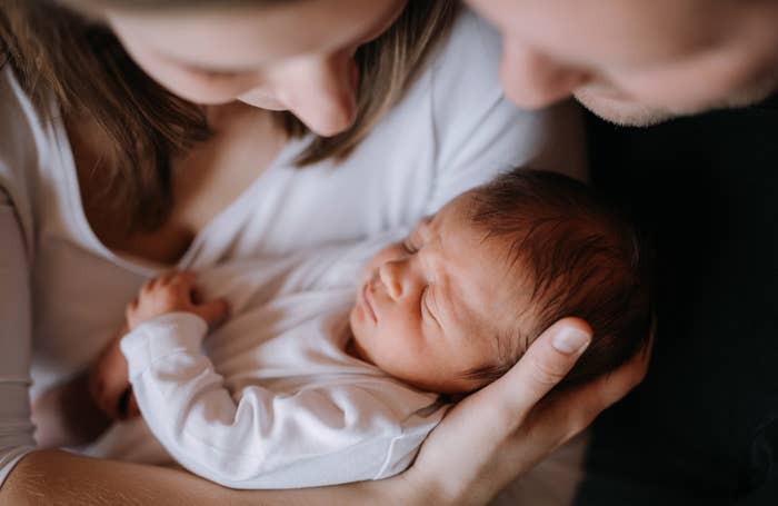 Parents holding a newborn baby