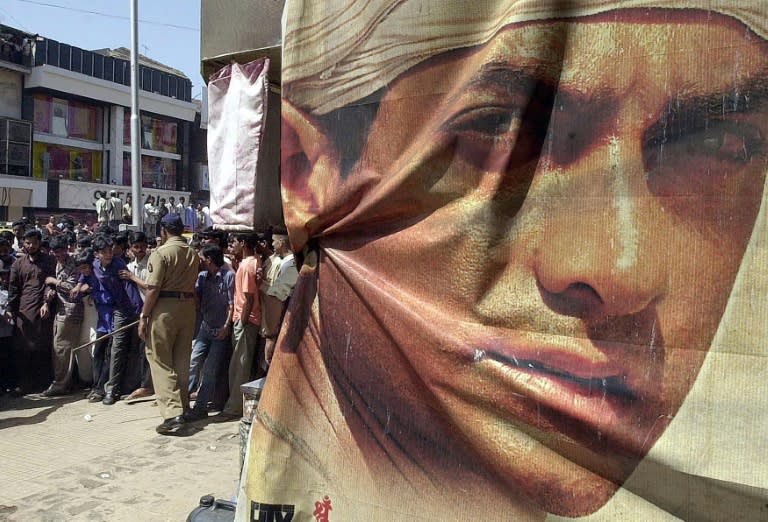 This file photo taken on March 25, 2002 shows a policeman (L) trying to control movie-goers outside a cinema where Indian actor/producer Aamir Khan's Oscar nominated film "Lagaan" (Land Tax) is being screened in Mumbai