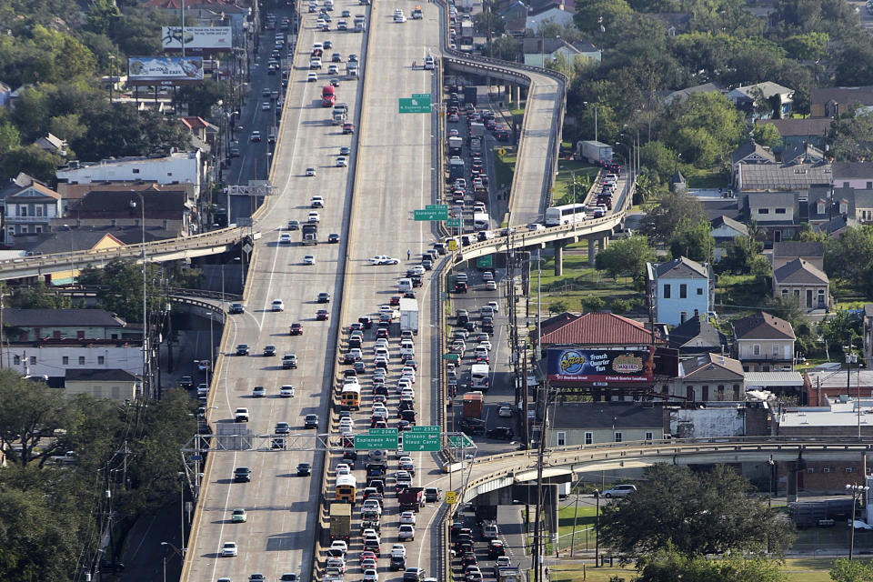 FILE - In this Sept. 19, 2012, file photo, traffic is diverted down the Esplanade Avenue exit following an accident on the elevated Interstate 10 expressway that runs above Claiborne Avenue in New Orleans. The expressway was built directly on top of Claiborne Avenue in the late 1960s — ripping up the oak trees and tearing apart a street sometimes called the “Main Street of Black New Orleans." (AP Photo/Gerald Herbert)