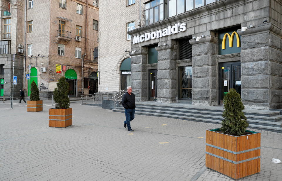 A man walks past a closed McDonald's restaurant in central Kyiv, Ukraine February 25, 2022. REUTERS/Valentyn Ogirenko