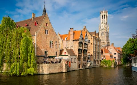 Eight million people visit little Bruges each year – but the locals don't seem to mind - Credit: GETTY