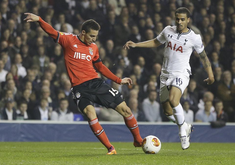 Benfica's Rodrigo, left, scores a goal past Tottenham's Kyle Naughton, right, during the Europa League round of 16 first leg soccer match between Tottenham Hotspur and SL Benfica at White Hart Lane stadium in London Thursday, March 13, 2014. (AP Photo/Kirsty Wigglesworth)