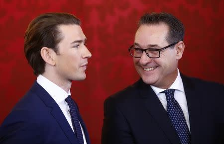 Head of the Freedom Party Heinz-Christian Strache (R) and head of the People's Party Sebastian Kurz react during the swearing-in ceremony of the new government in Vienna, December 18, 2017 REUTERS/Leonhard Foeger