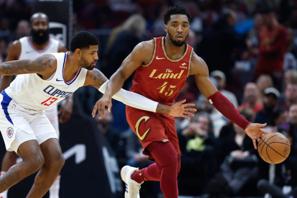 Cavaliers guard Donovan Mitchell controls the ball against Los Angeles Clippers forward Paul George during the first half Monday in Cleveland.