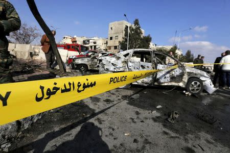 Syrian army soldiers and civilians inspect the site of a suicide bombing at a police officers' club in a residential district of Damascus, in Masaken Barza, Syria February 9, 2016. REUTERS/Omar Sanadiki