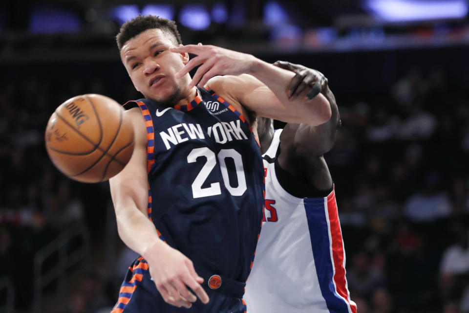 Detroit Pistons forward Tony Snell grabs New York Knicks forward Kevin Knox II (20)who was defending Smell beneath the Pistons' basket during the first half of an NBA basketball game in New York, Sunday, March 8, 2020. (AP Photo/Kathy Willens)