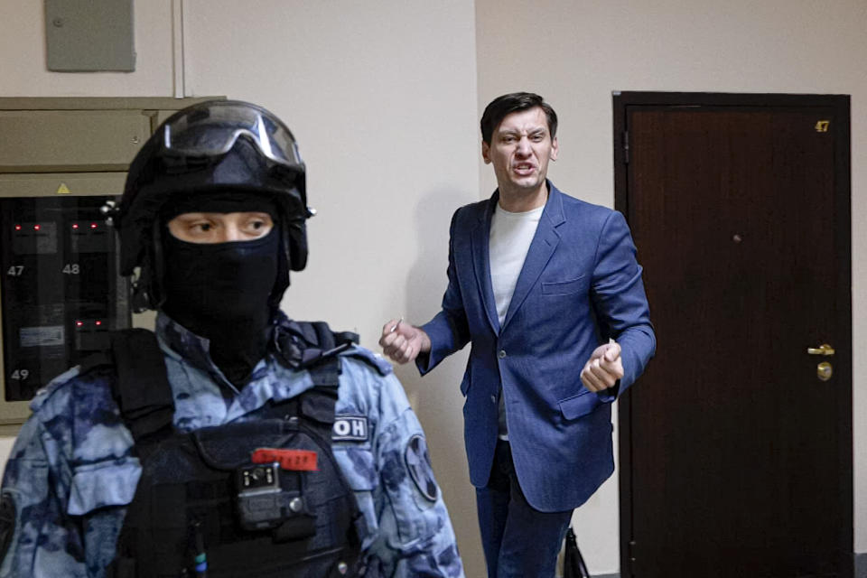 In this photo taken from video, Russian opposition activist Dmitry Gudkov gestures speaking to the media as police search at his country home outside Moscow, Russia, Tuesday, June 1, 2021. Russian authorities are cracking down on dissent before a crucial parliamentary election in September, in what a leading Kremlin critic on Tuesday described as an attempt to sideline opponents. Also on Tuesday, police raided the country home of opposition politician Dmitry Gudkov, a former lawmaker who has aspired to run for parliament. At least two of his associates also had their homes searched.(AP Photo/Daniel Kozin)