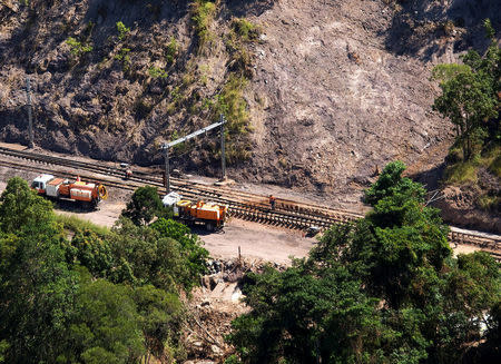 Workmen repair a section of the Goonyella rail system, that services coal mines in the Bowen Bason, after a landslide damaged the tracks as a result of heavy rain associated with Cyclone Debbie, at a section called Black Mountain located near the Queensland town of Mackay in Australia, April 11, 2017. REUTERS/Daryl Wright