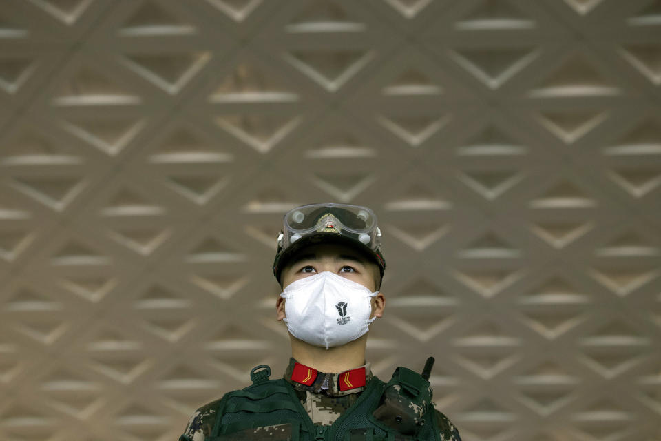 A security officer wearing a face mask to protect against the spread of new coronavirus stands guard at Wuhan Tianhe International Airport (Ng Han Guan/AP)