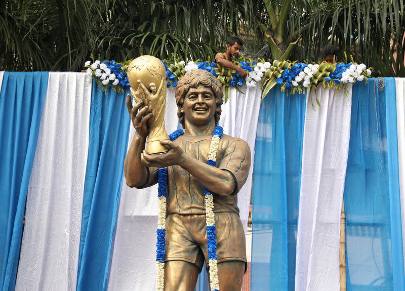 A garlanded statue of Argentine soccer great Diego Maradona is seen before a prayer meeting, in Kolkata