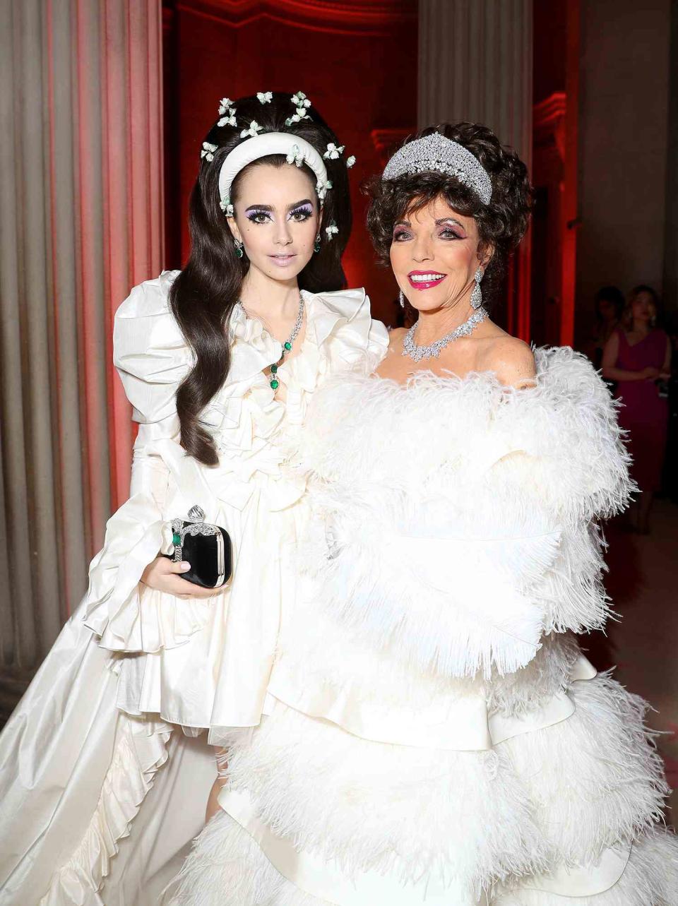 <p>Kevin Tachman/MG19/Getty</p> Lily Collins (left) and Joan Collins attend The 2019 Met Gala Celebrating Camp: Notes on Fashion at Metropolitan Museum of Art on May 06, 2019 in New York City
