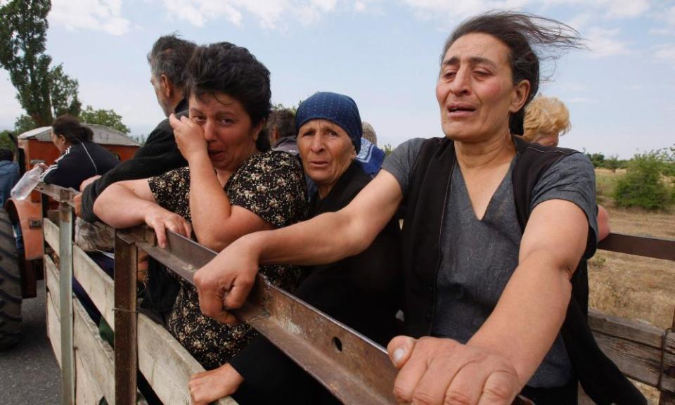 Georgian women cry as they leave their village near the town of Tskhinvali, Georgia, 10 August 2008.