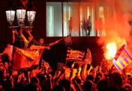 Barcelona's supporters celebrate at Canaletas fountain in Las Ramblas of Barcelona after their team won the Spanish League title. Barcelona were crowned Spanish champions for the third successive season with a 1-1 draw at Levante clinching a 21st domestic title with two games to spare