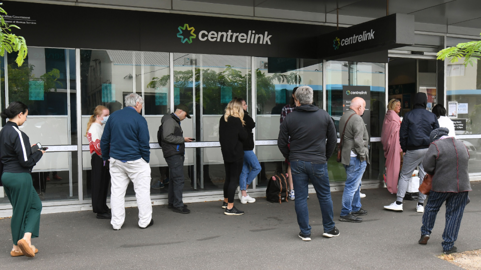 Australians line up outside a Centrelink office.