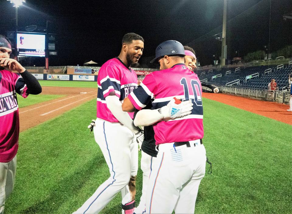 Blue Wahoos manager Kevin Randel (10) congratulates Victor Victor Mesa after his dramatic game-winning, walkoff hit Sunday, May 15, 2022.