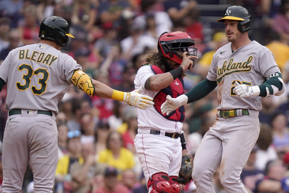 Oakland Athletics' Brent Rooker, right, celebrates after his home run with JJ Bleday (33) in front of Boston Red Sox's Jorge Alfaro, center, in the fifth inning of a baseball game, Sunday, July 9, 2023, in Boston. (AP Photo/Steven Senne)