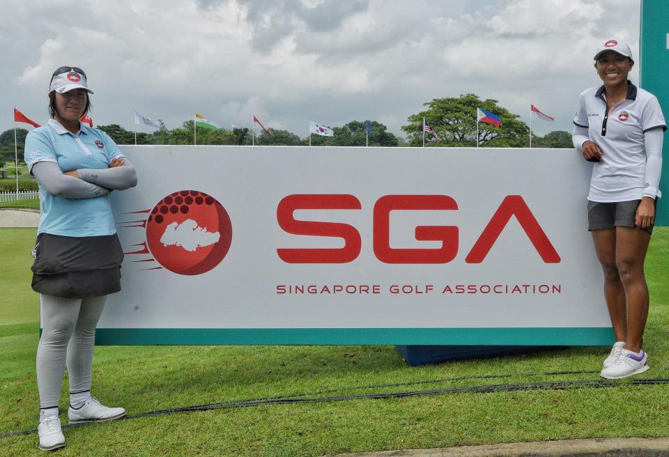 Singapore national golfers Chen Xingtong (left) and Aloysa Atienza with SGA's new logo. (PHOTO: SGA)