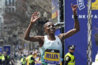 Hellen Obiri, of Kenya, celebrates after crossing the finish line to win the women's division at the Boston Marathon, Monday, April 15, 2024, in Boston. (AP Photo/Steven Senne)