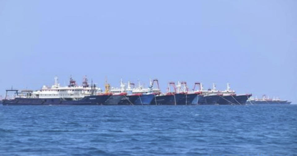 In this March 7, 2021, handout photo provided by the Philippine Coast Guard/National Task Force-West Philippine Sea, some of the 220 Chinese vessels are seen moored at Whitsun Reef, South China Sea. Swarms of Chinese vessels have dumped human waste and sewage for years in a disputed South China Sea territory, causing algae blooms that have damaged coral reefs and threatened fish in an unfolding catastrophe, a U.S.-based expert said Monday July 12, 2021. (Philippine Coast Guard/National Task Force-West Philippine Sea via AP)