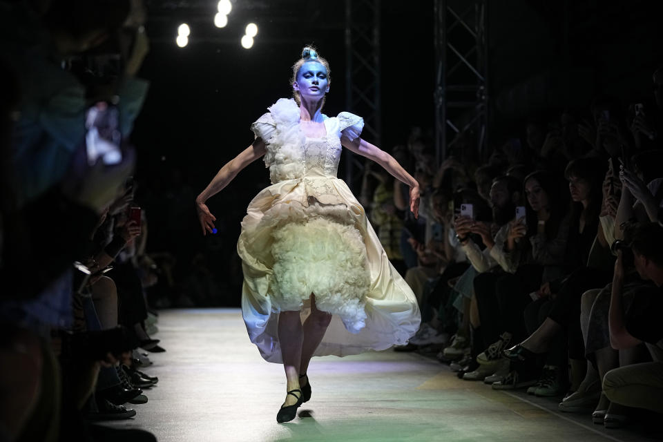 A models displays a collection by Russian designer Polina Mircheva during the Fashion Week at Zaryadye Park near Red Square in Moscow, Russia, Wednesday, June 22, 2022. Chic and adventurous models and couturiers have been spread all over the Russian capital for Moscow Fashion Week, flaunting their designs in venues ranging from a sprawling Stalin-era propaganda exposition to a large park near the Kremlin admired for its innovative features. (AP Photo/Alexander Zemlianichenko)