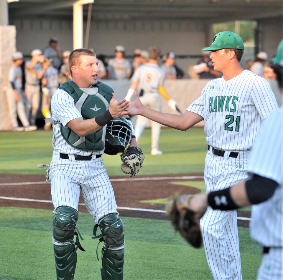 Iowa Park's Jaydon Southard high fives his teammate Ty Cunningham (21) after a good inning against Stephenville during the Region I-4A quarterfinals in Iowa Park on Wednesday, May 18, 2022.