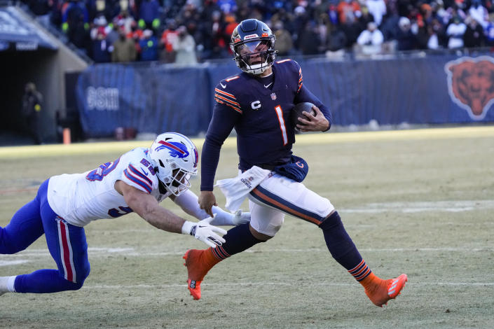 Chicago Bears quarterback Justin Fields (1) breaks away from Buffalo Bills linebacker Matt Milano (58) in the second half of an NFL football game in Chicago, Saturday, Dec. 24, 2022. (AP Photo/Nam Y. Huh)