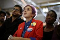 People listen to U.S. Democratic presidential nominee Hillary Clinton speak at a voter registration rally at Wayne State University in Detroit, Michigan, U.S. October 10, 2016. REUTERS/Lucy Nicholson