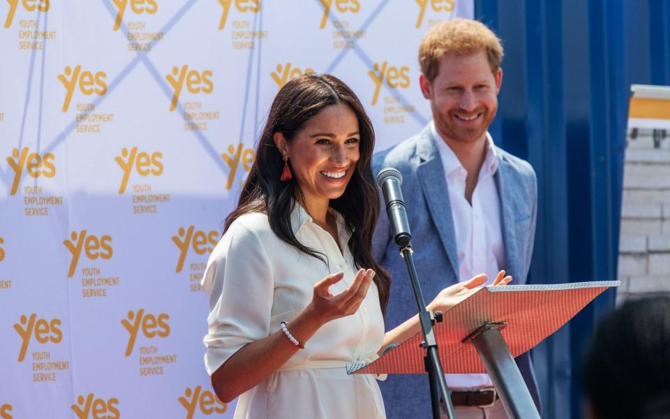 The Duchess of Sussex is watched by husband Duke of Sussex as she delivers a speech at the Youth Employment Services Hub in Tembisa township, Johannesburg. - AFP