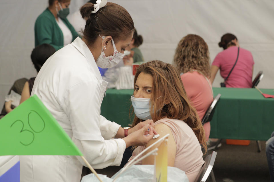 Medical personnel inside a vaccination unit at the Campo Marte facilities in Mexico City apply doses of the Pfizer-BioNTech biologic against COVID-19 to pregnant women and people between 40 and 49 years of age in the Miguel Hidalgo district. (Gerardo Vieyra/NurPhoto via Getty Images)