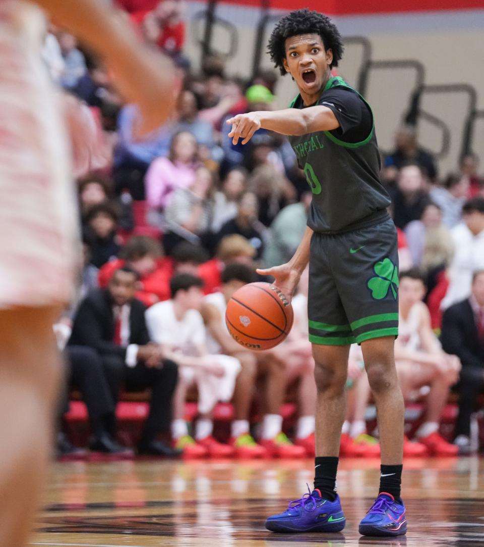 Cathedral Fighting Irish guard Lebron Gough (0) yells to players up the court Friday, Feb. 9, 2024, during the game at Fishers High School in Fishers. The Fishers Tigers defeated the Cathedral Fighting Irish, 56-51.