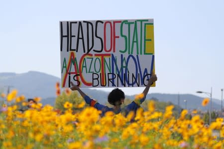 A demonstrator holds a placard during a protest march during the G7 summit, in Irun