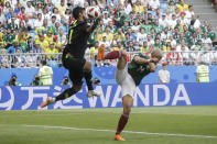 <p>Brazil goalkeeper Alisson, left, blocks a kick by Mexico’s Javier Hernandez, right, during the round of 16 match between Brazil and Mexico at the 2018 soccer World Cup in the Samara Arena, in Samara, Russia, Monday, July 2, 2018. (AP Photo/Andre Penner) </p>