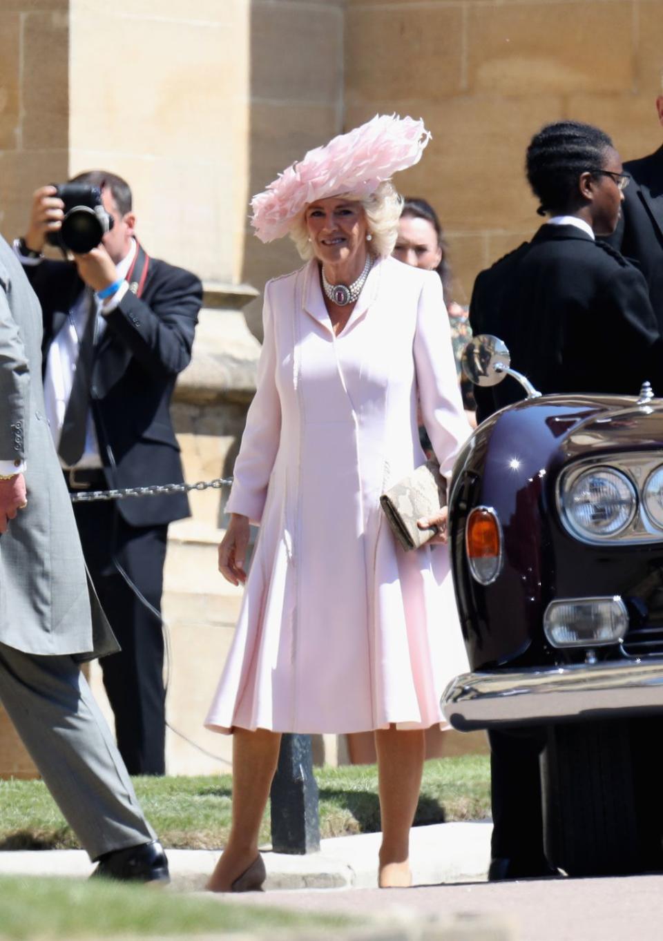 Camilla, Duchess of Cornwall wore a feathered Philip Treacy hat and a coat dress by Anna Valentine.