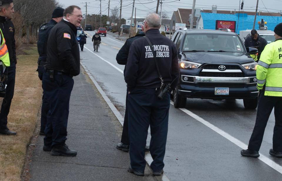 A Yarmouth police officer interviews the driver of an SUV with a big dent on the passenger's side hood at the scene of a crash across from the Sunbird Cape Cod Resort at 216 Route 28 in West Yarmouth on Tuesday morning where a detail officer was struck. The officer was taken to South Shore Hospital by Yarmouth Fire Department.