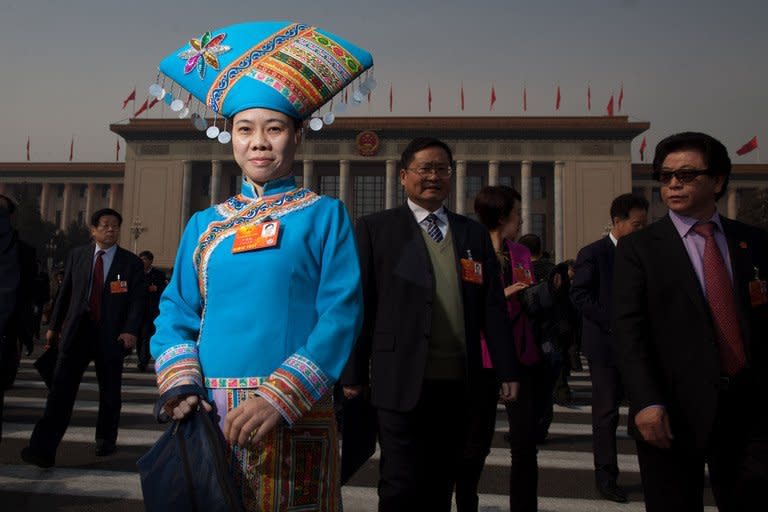 Delegates leave the Great Hall of the People following the opening session of the National People's Congress (NPC) in Beijing on March 5, 2013. China targeted 2013 economic growth of 7.5 percent and vowed to tackle corruption and improve the quality of life as an annual parliamentary session to seal its transition to new leadership started