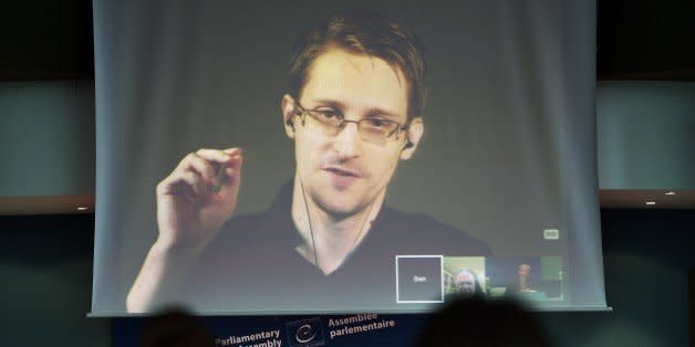 NSA former intelligence contractor Edward Snowden talks as he participates via video link from Russia (Above) to a parliamentary hearing on the subject of 'Improving the protection of whistleblowers', held by Dutch rapporteur Pieter Omtzigt (Bottom C) on June 23, 2015, at the Council of Europe in Strasbourg, northeastern France. Snowden, who has been granted asylum in Russia, is being sought by Washington which has branded him a hacker and a traitor who endangered lives by revealing the extent of the NSA spying program. AFP PHOTO / FREDERICK FLORIN        (Photo credit should read FREDERICK FLORIN/AFP/Getty Images) (Photo: )