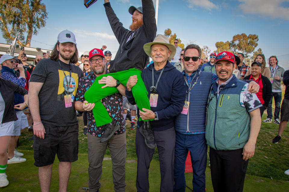 Bill Murray and fans hoist the winner of the putting contest. Image: Project Venkman