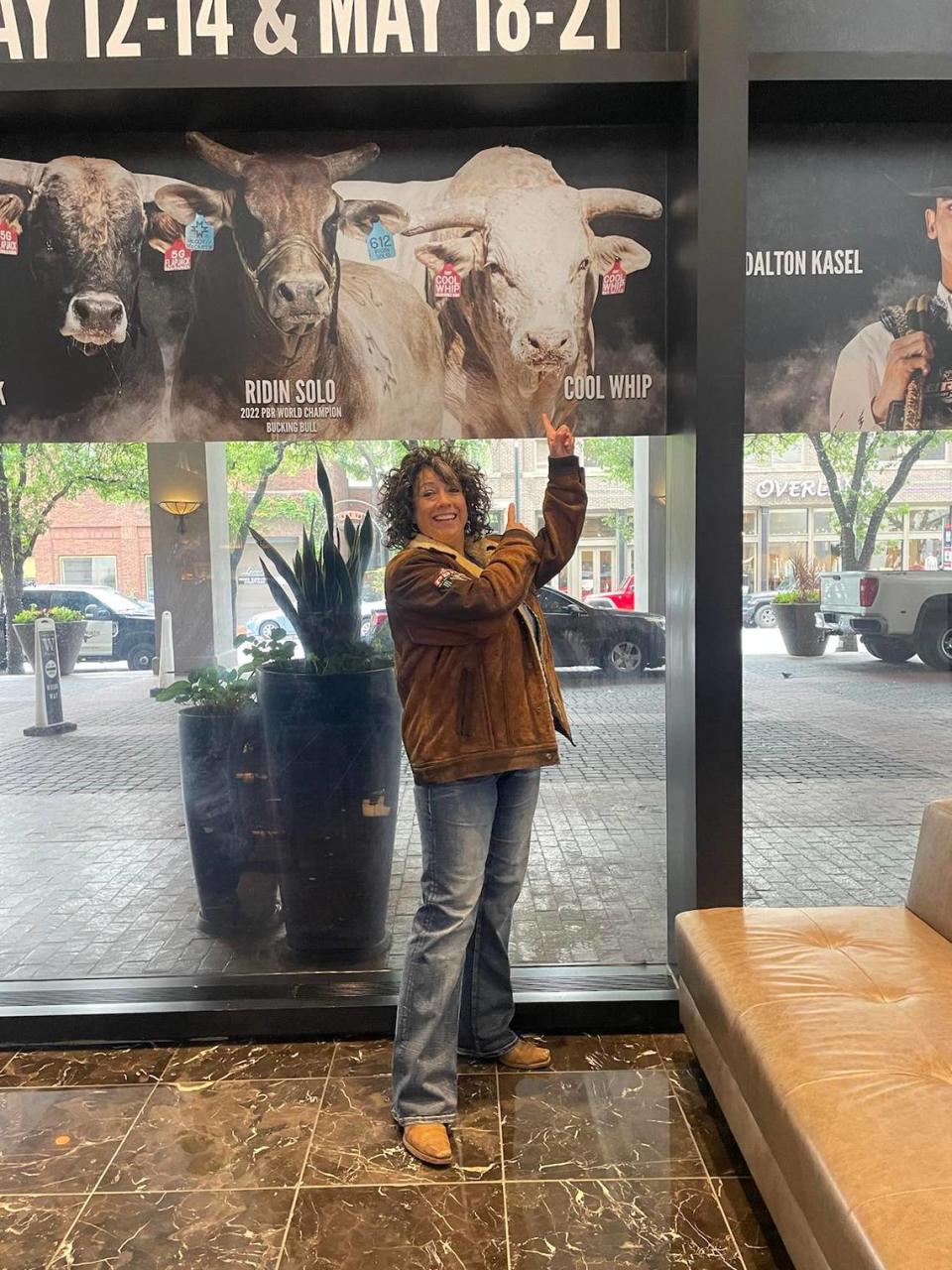 Wichita native Staci Addison poses in front of a sign promoting her bull, Cool Whip, on the Unleash the Beast Tour on PBR. Staci Addison/Courtesy