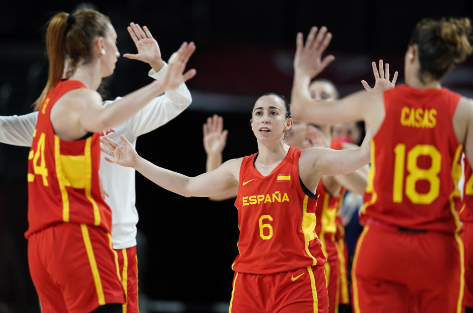 Spain's Silvia Dominguez (6), center, celebrates with teammates during women's basketball preliminary round game against Canada at the 2020 Summer Olympics, Sunday, Aug. 1, 2021, in Saitama, Japan. (AP Photo/Charlie Neibergall)