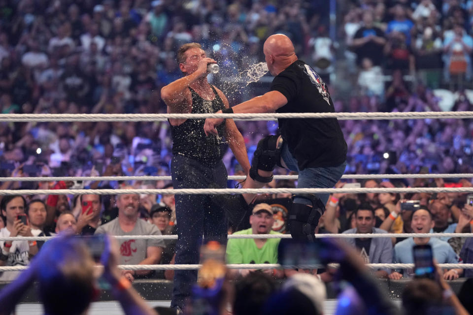 Apr 3, 2022; Arlington, TX, USA; Stone Cold Steve Austin stuns WWE owner Vince McMahon during WrestleMania 38 at AT&T Stadium. Mandatory Credit: Joe Camporeale-USA TODAY Sports