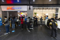 People shop outdoors at KMart on Bourke Street in Melbourne, Friday, Oct. 22, 2021. Melbourne, Australia’s most populous city after Sydney, came out of 77 days of lockdown on Friday after Victoria state reached a benchmark of 70% of the target population fully vaccinated. (Daniel Pockett/AAP Image via AP)